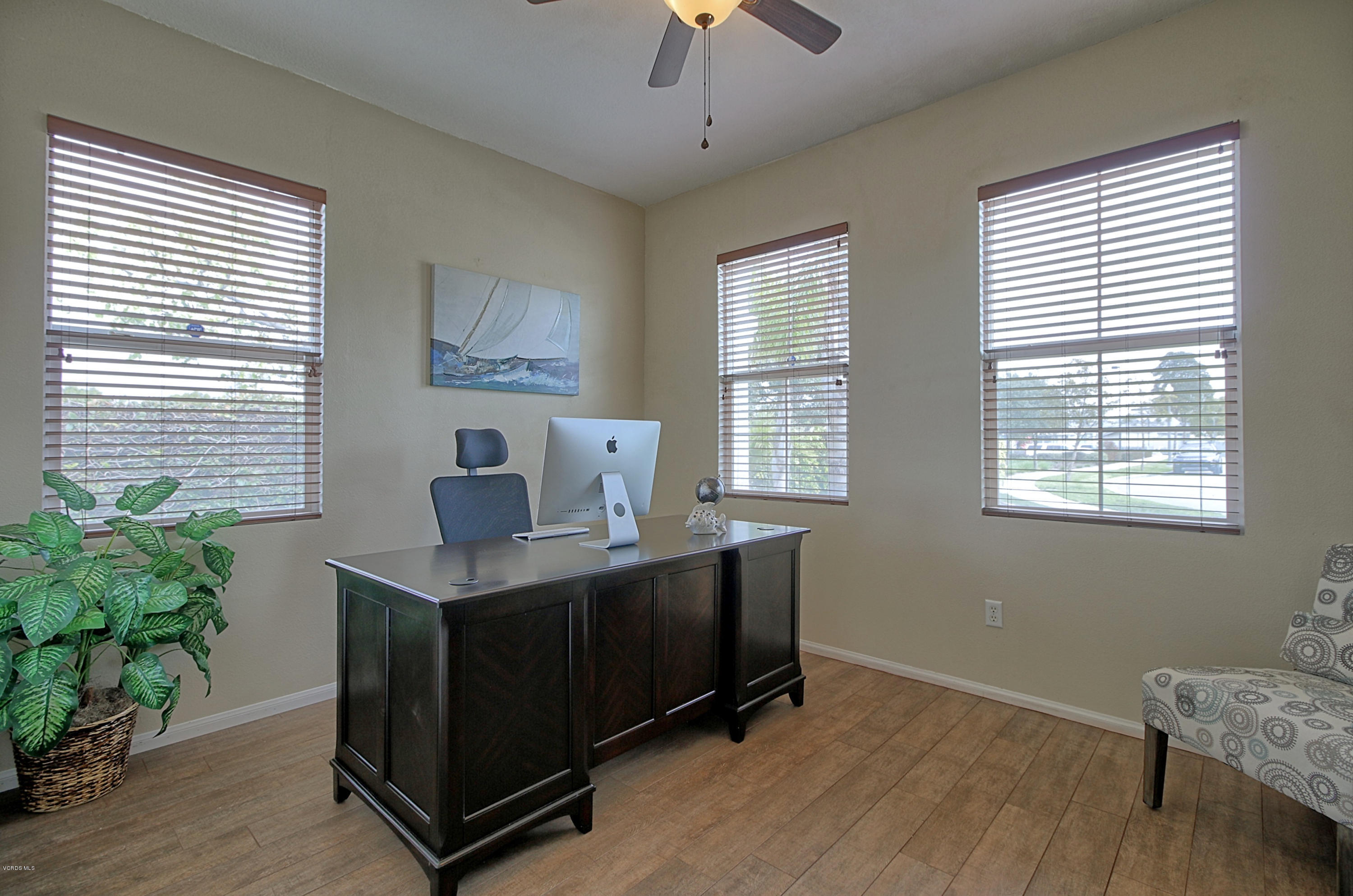 3305 Dunkirk Drive Oxnard, CA 93035 - Photo 14 of 20 a view of workspace with wooden floor windows cabinet and windows