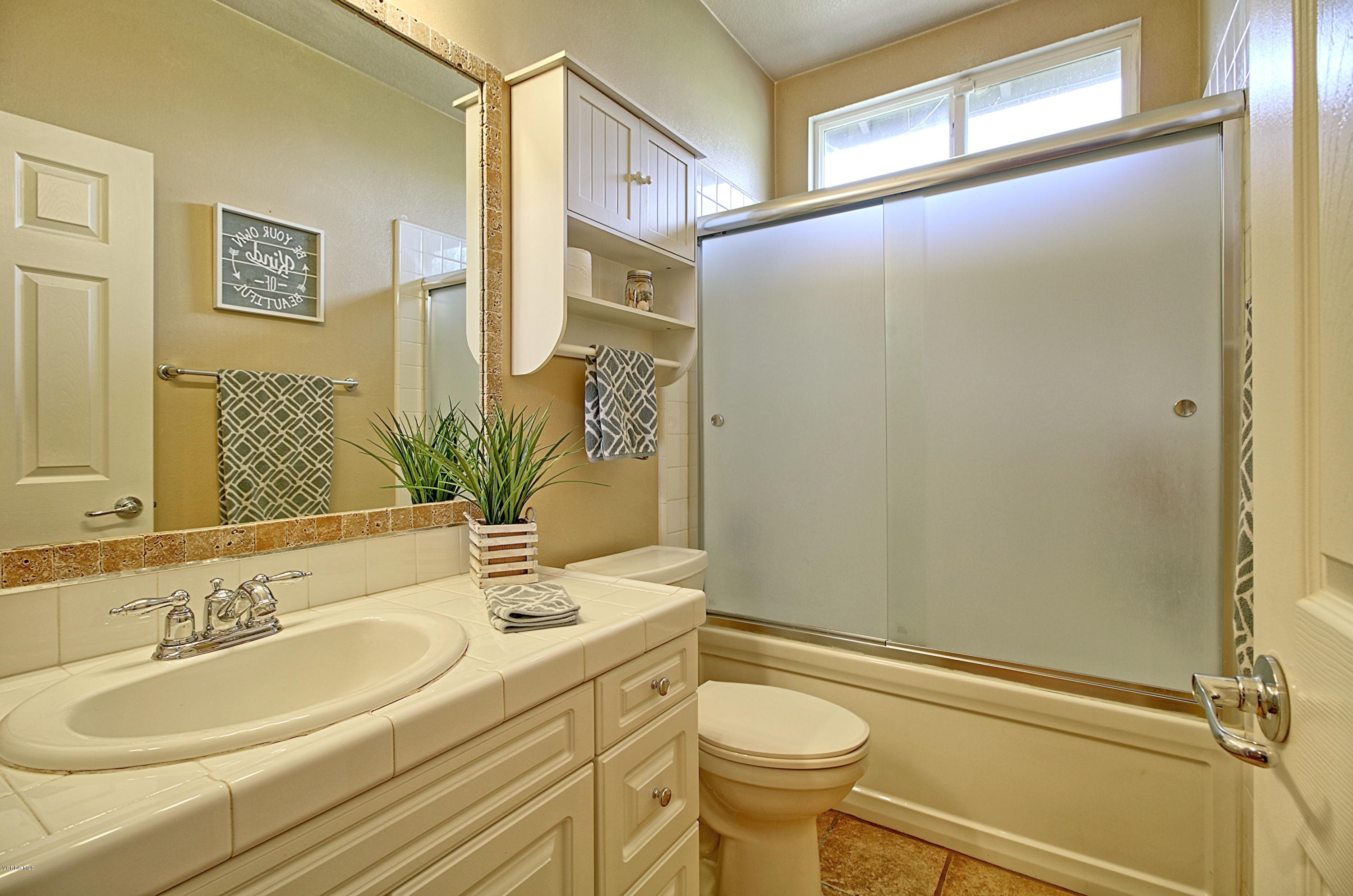 3305 Dunkirk Drive Oxnard, CA 93035 - Photo 16 of 20 a bathroom with a sink a toilet and a mirror