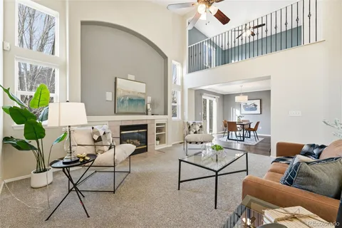 a living room with furniture a rug and a chandelier