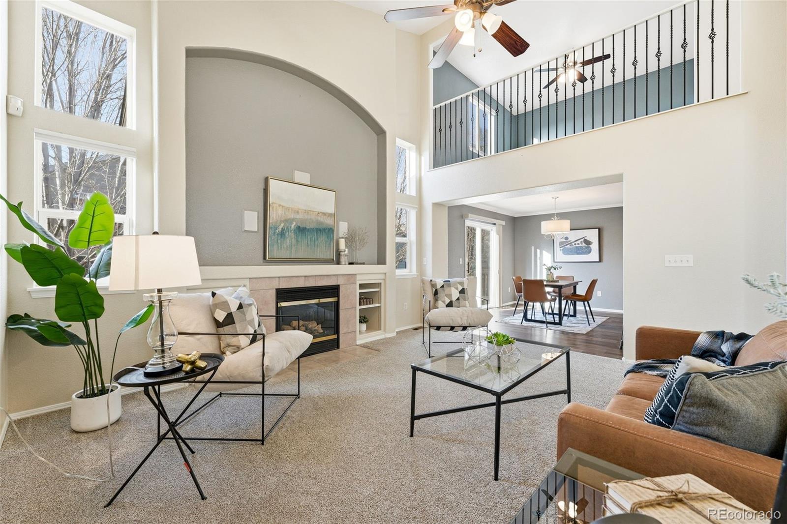 6471 St Vrain Ranch Boulevard Firestone, CO 80504 - Photo 11 of 45 a living room with furniture a rug and a chandelier