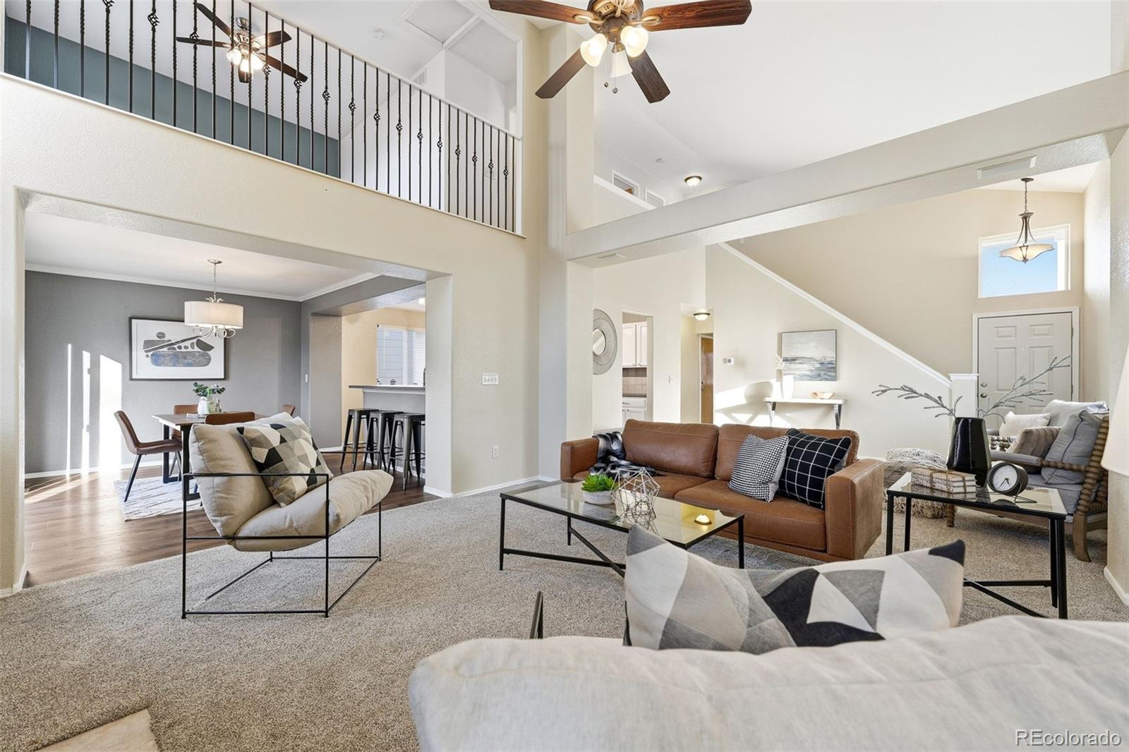 6471 St Vrain Ranch Boulevard Firestone, CO 80504 - Photo 12 of 45 a living room with furniture and a ceiling fan