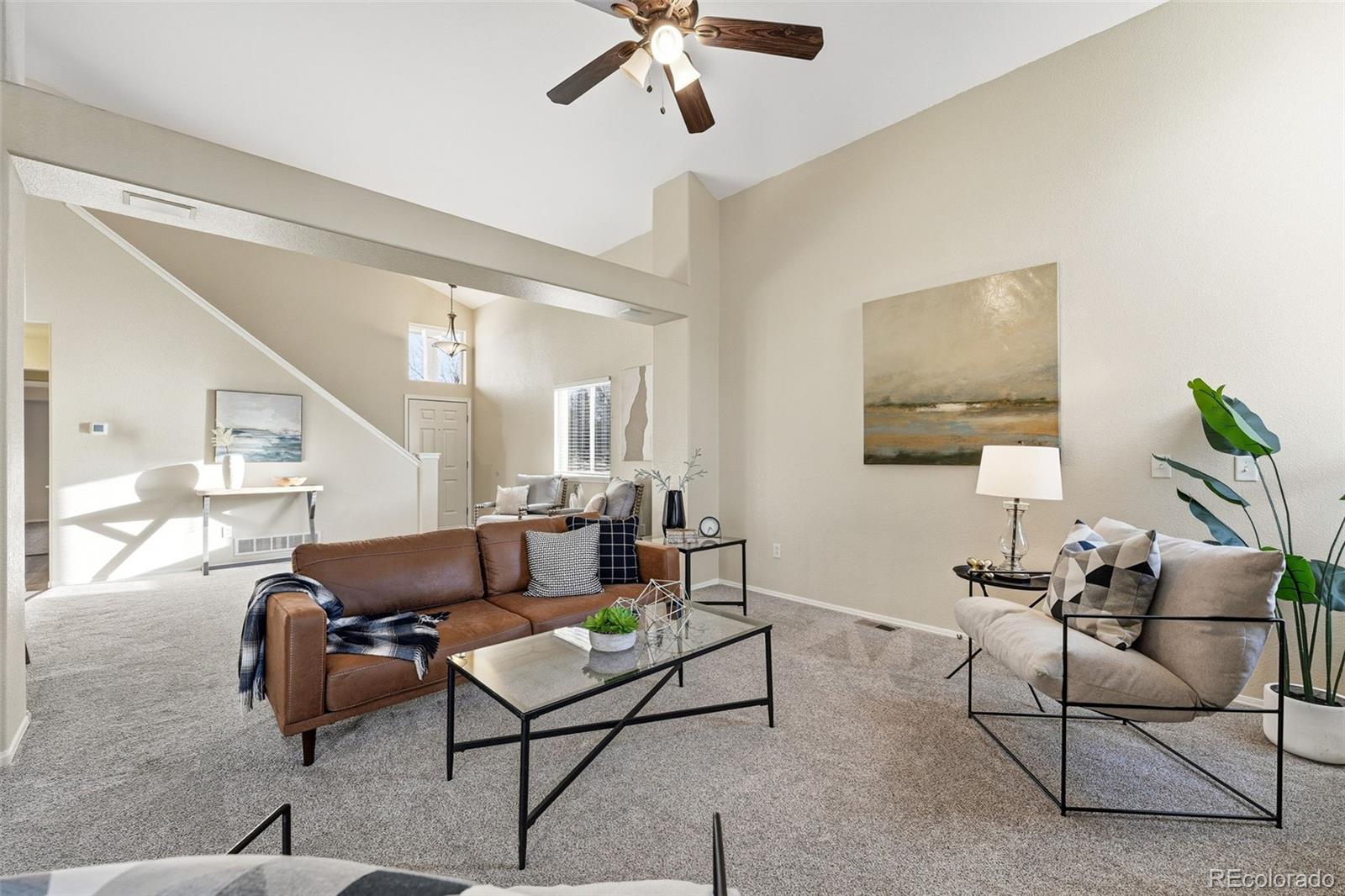 6471 St Vrain Ranch Boulevard Firestone, CO 80504 - Photo 13 of 45 a living room with furniture and a wooden floor