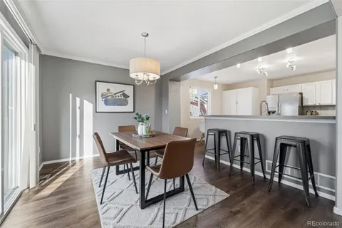 a view of a dining room with furniture wooden floor and chandelier