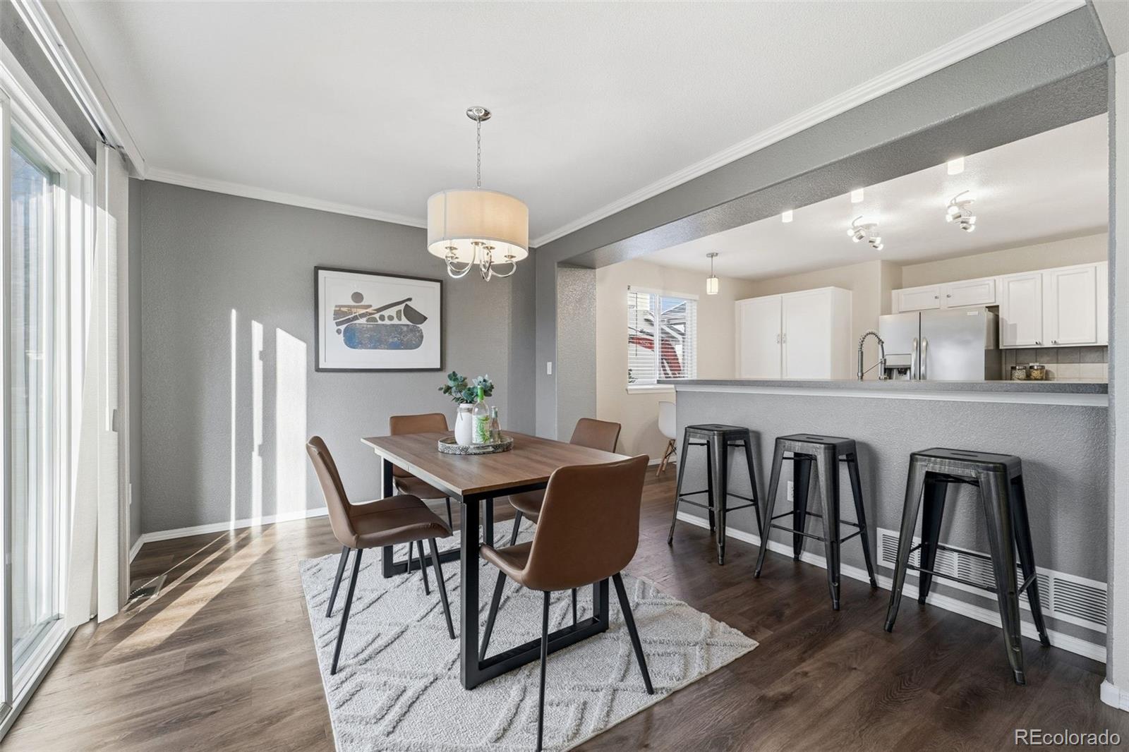 6471 St Vrain Ranch Boulevard Firestone, CO 80504 - Photo 14 of 45 a view of a dining room with furniture wooden floor and chandelier