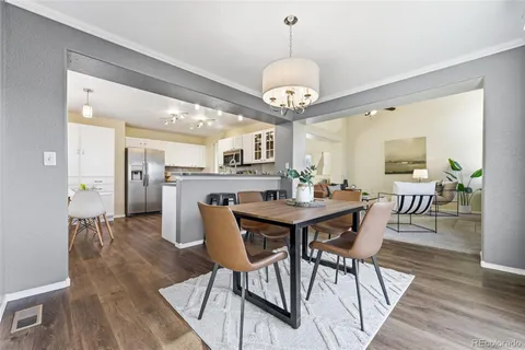 a view of a dining room with furniture wooden floor and chandelier
