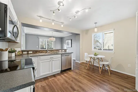 a large kitchen with cabinets a sink and appliances in it