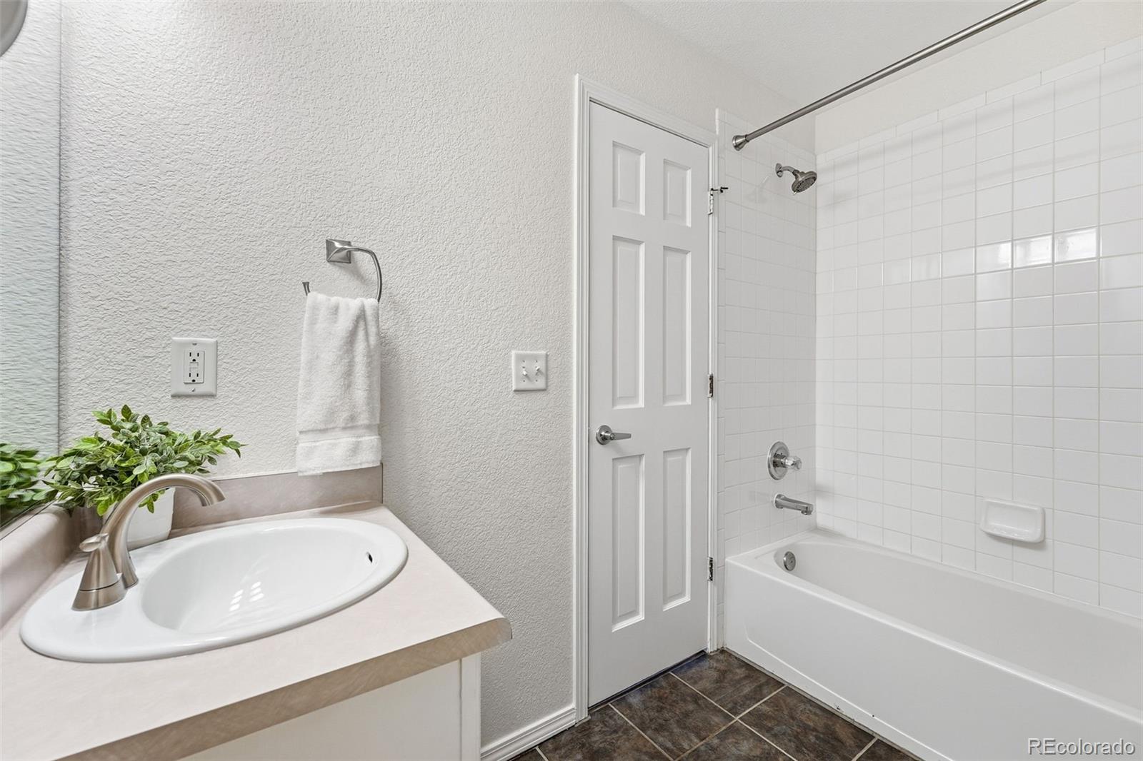 6471 St Vrain Ranch Boulevard Firestone, CO 80504 - Photo 20 of 45 a bathroom with a sink a bathtub and a mirror