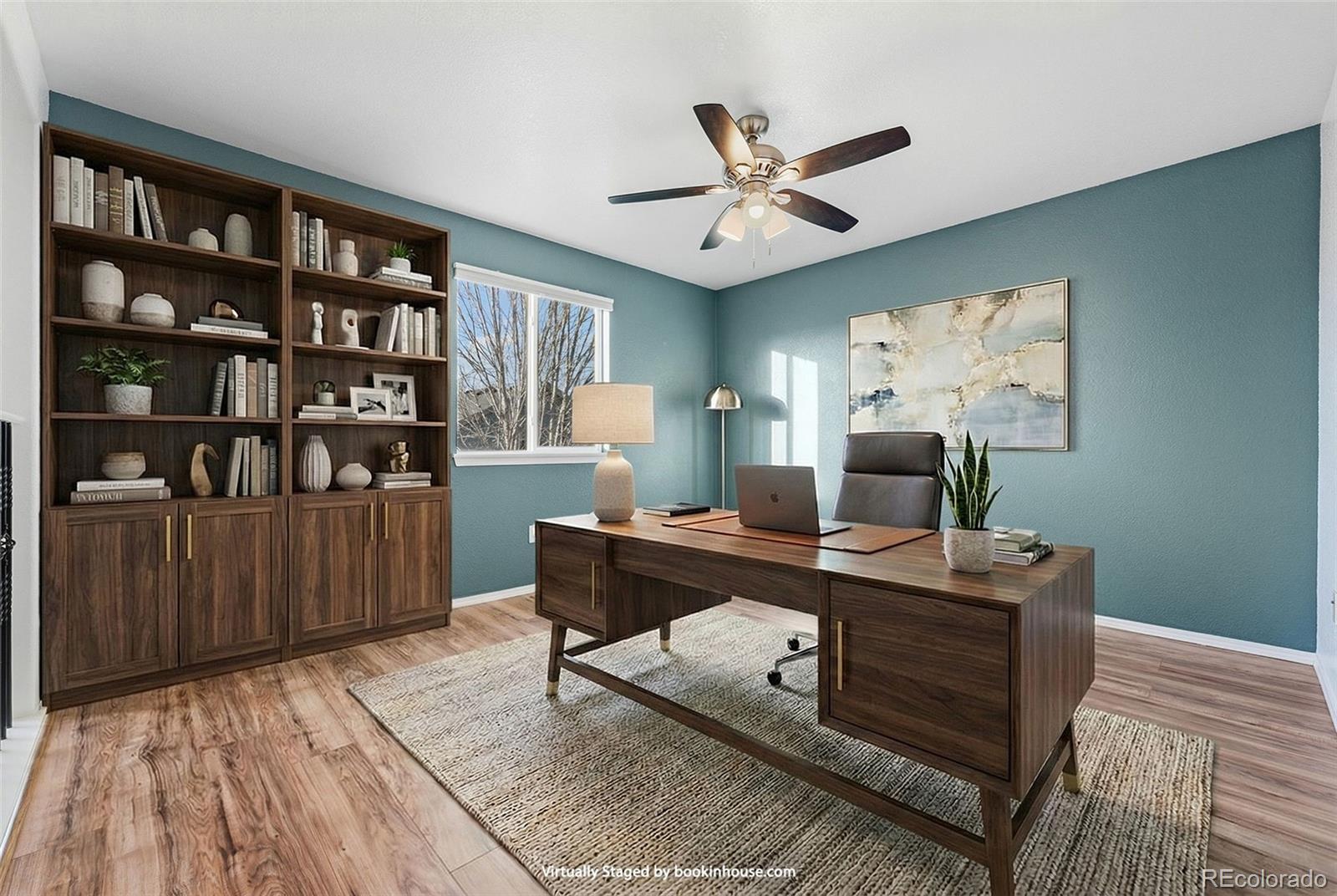 6471 St Vrain Ranch Boulevard Firestone, CO 80504 - Photo 24 of 45 a view of a workspace with furniture and wooden floor