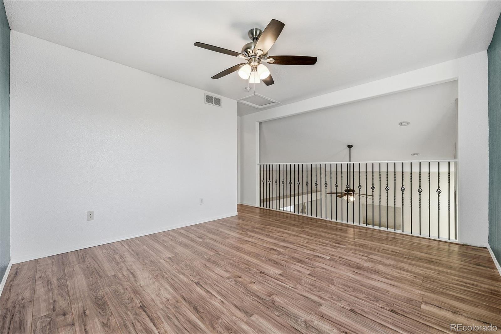 6471 St Vrain Ranch Boulevard Firestone, CO 80504 - Photo 26 of 45 a view of a room with wooden floor