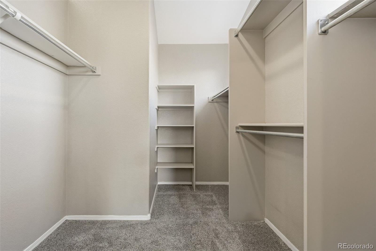 6471 St Vrain Ranch Boulevard Firestone, CO 80504 - Photo 29 of 45 a view of walk in closet with empty racks