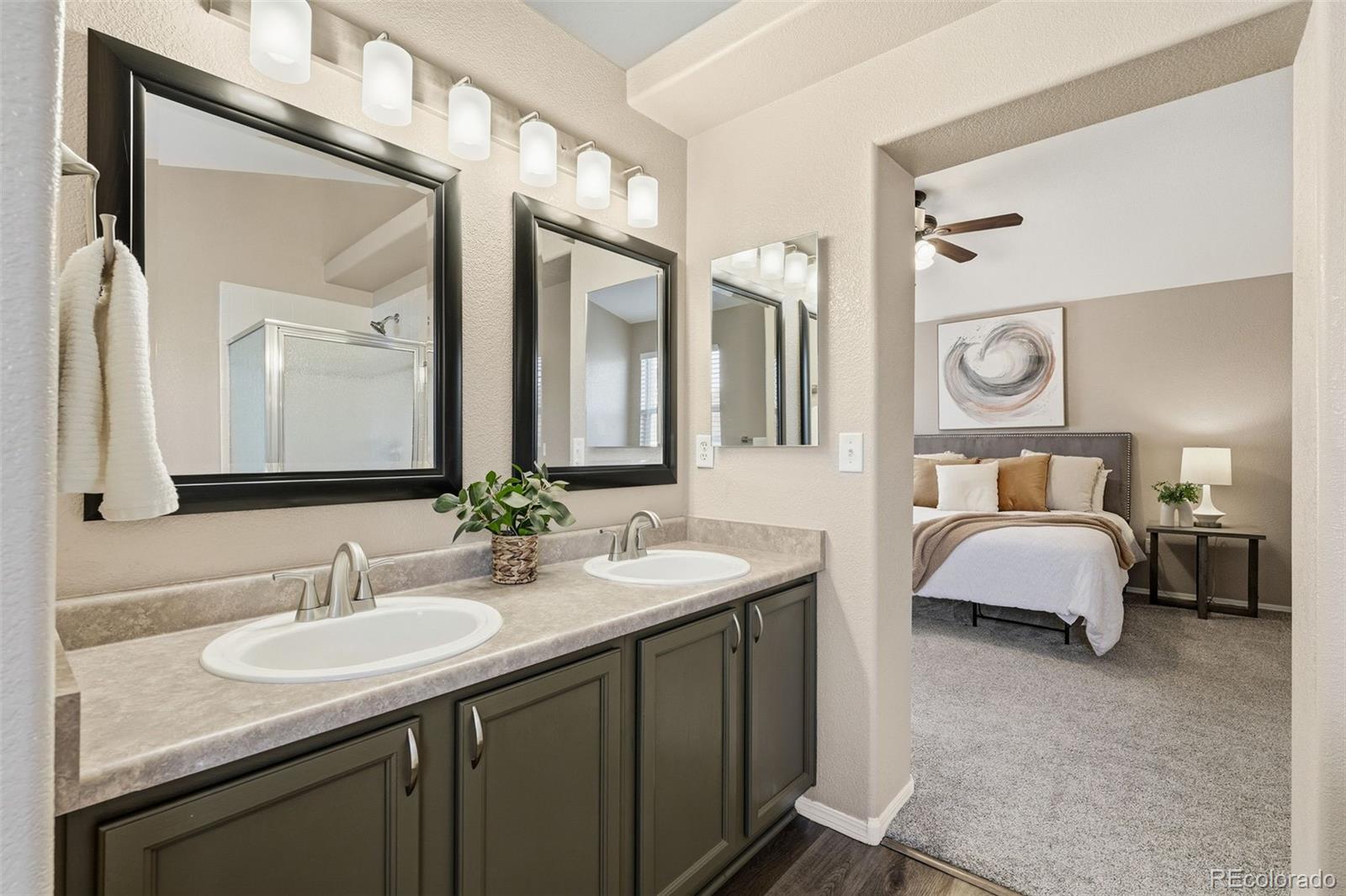 6471 St Vrain Ranch Boulevard Firestone, CO 80504 - Photo 31 of 45 a en suite bathroom with a granite countertop sink and a mirror
