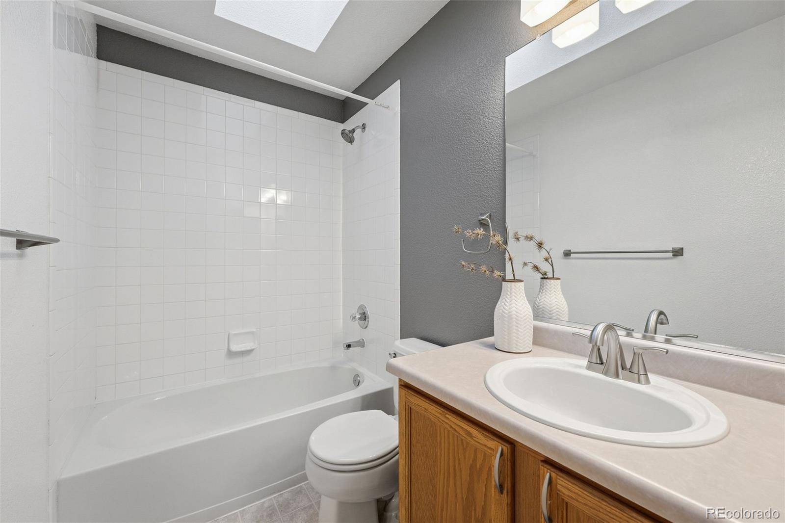 6471 St Vrain Ranch Boulevard Firestone, CO 80504 - Photo 38 of 45 a bathroom with a granite countertop sink toilet and shower