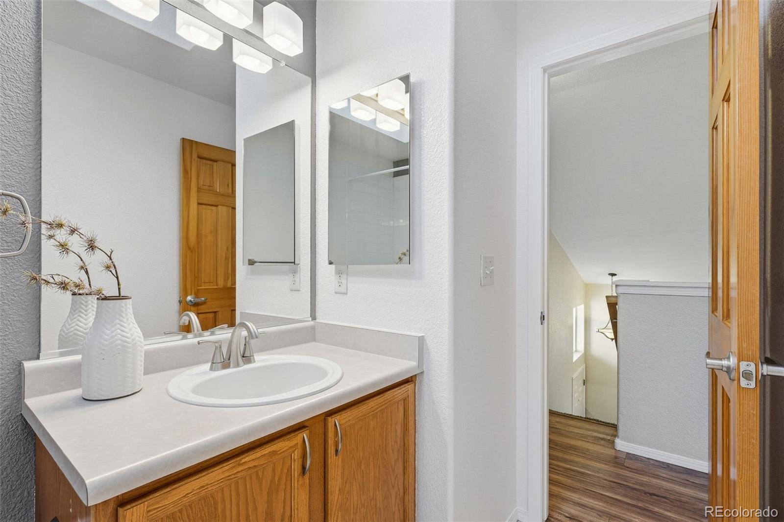 6471 St Vrain Ranch Boulevard Firestone, CO 80504 - Photo 39 of 45 a bathroom with a sink and a mirror