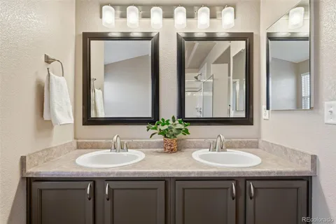 a bathroom with sinks granite and a sink