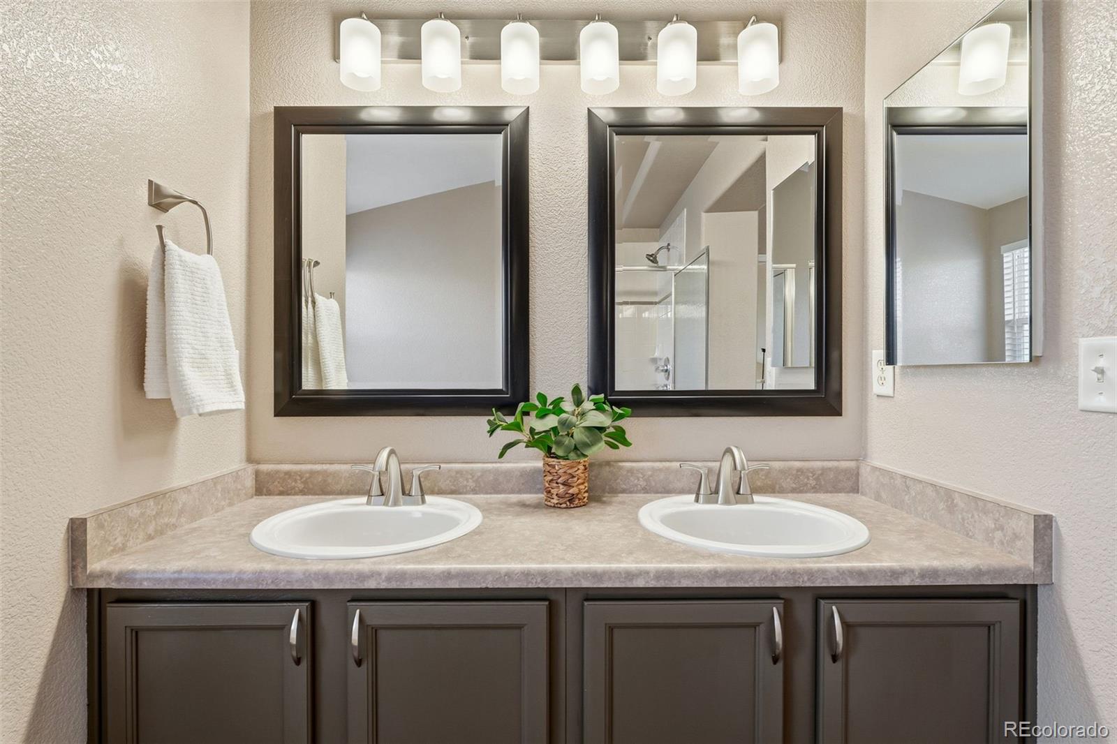 6471 St Vrain Ranch Boulevard Firestone, CO 80504 - Photo 5 of 45 a bathroom with sinks granite and a sink