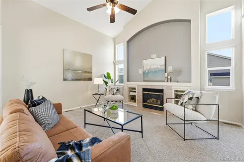a living room with furniture a fireplace and a window