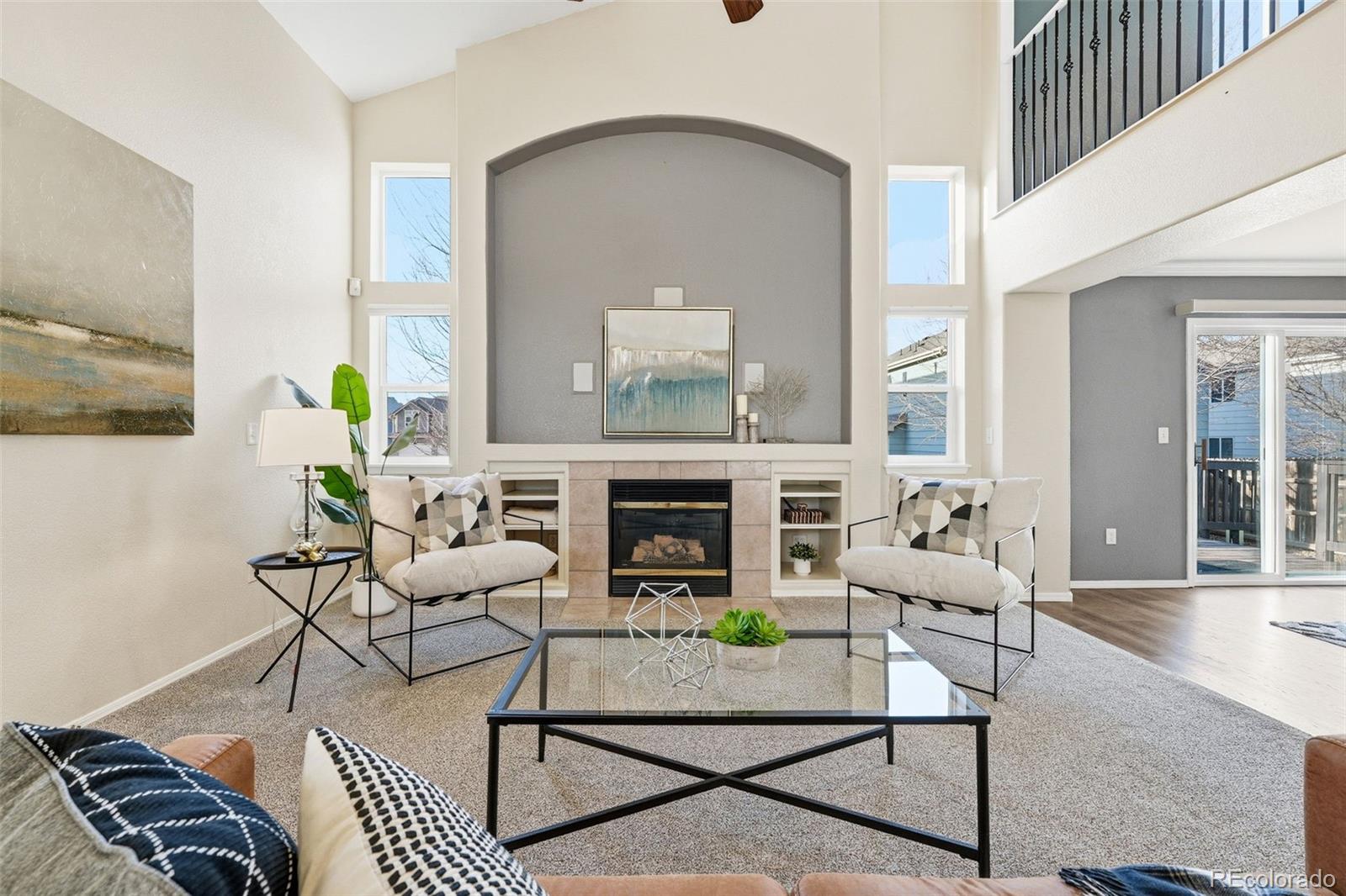 6471 St Vrain Ranch Boulevard Firestone, CO 80504 - Photo 10 of 45 a living room with furniture and a fireplace
