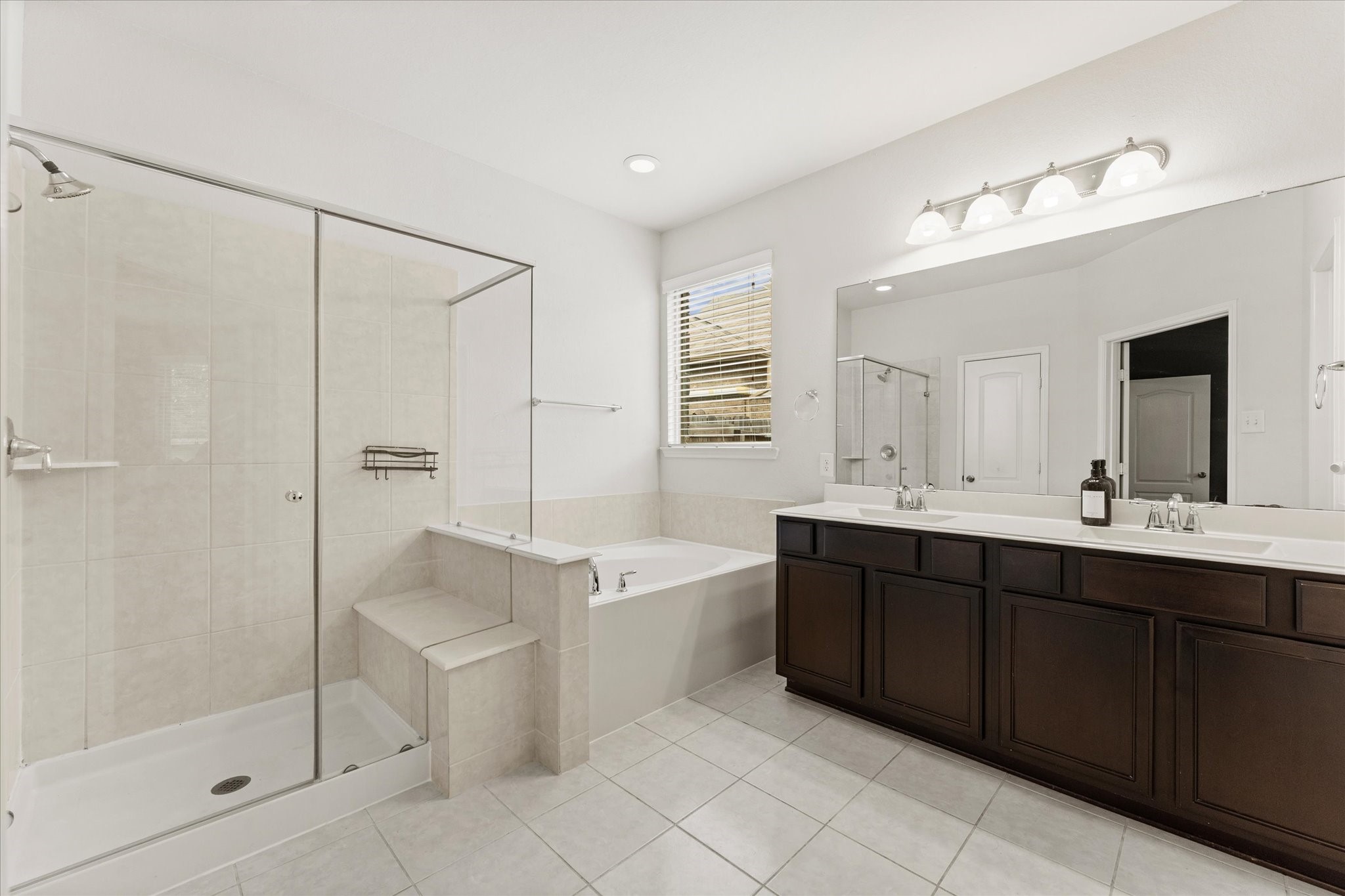 3402 Dryer Park Drive Spring, TX 77373 - Photo 20 of 40 Primary bathroom features a spacious design with a glass enclosed shower, separate bathtub, double vanity with ample storage.