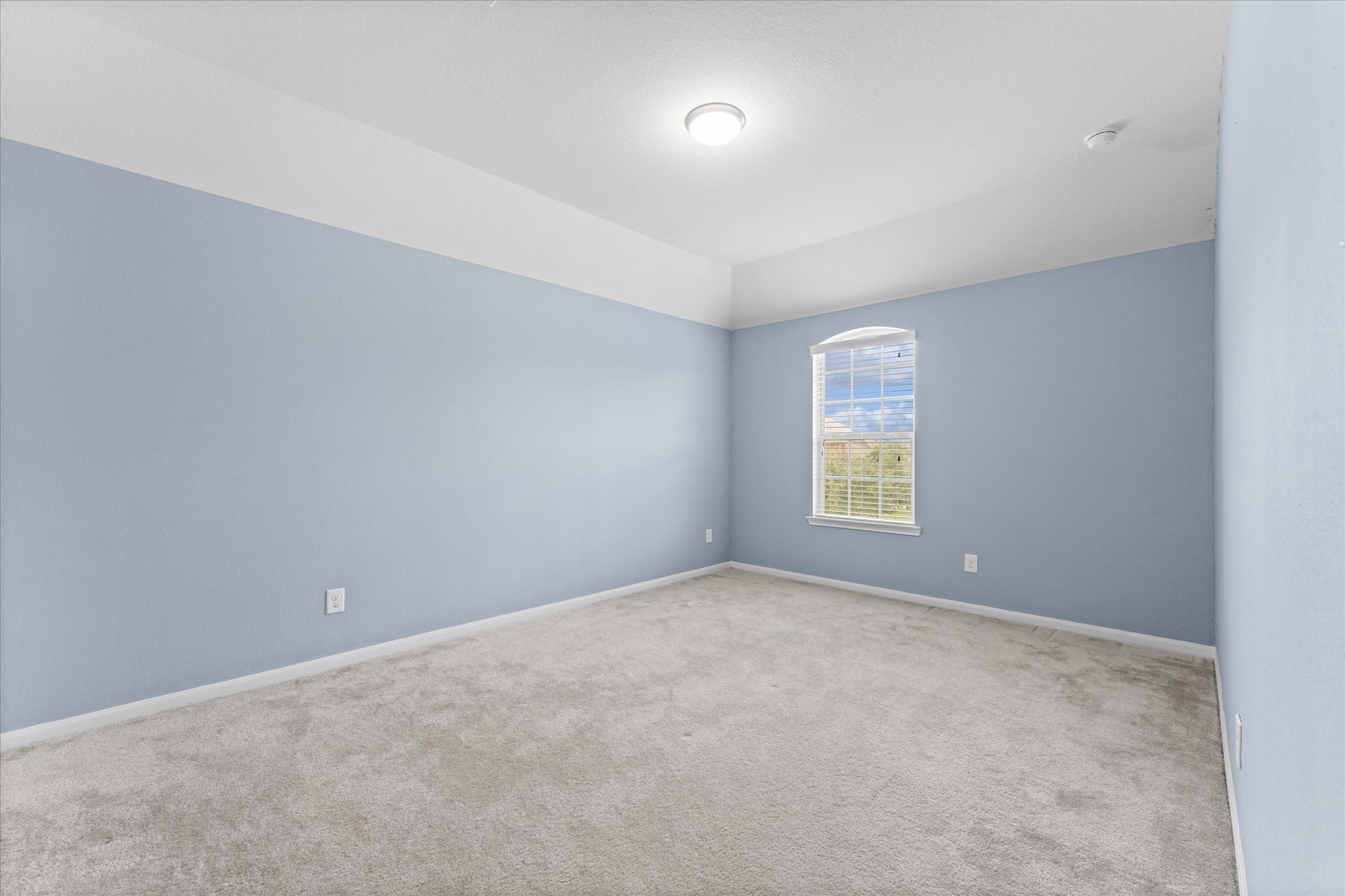 3402 Dryer Park Drive Spring, TX 77373 - Photo 31 of 40 Spacious fourth bedroom with natural light and soft carpeting, perfect for guests or a home office.