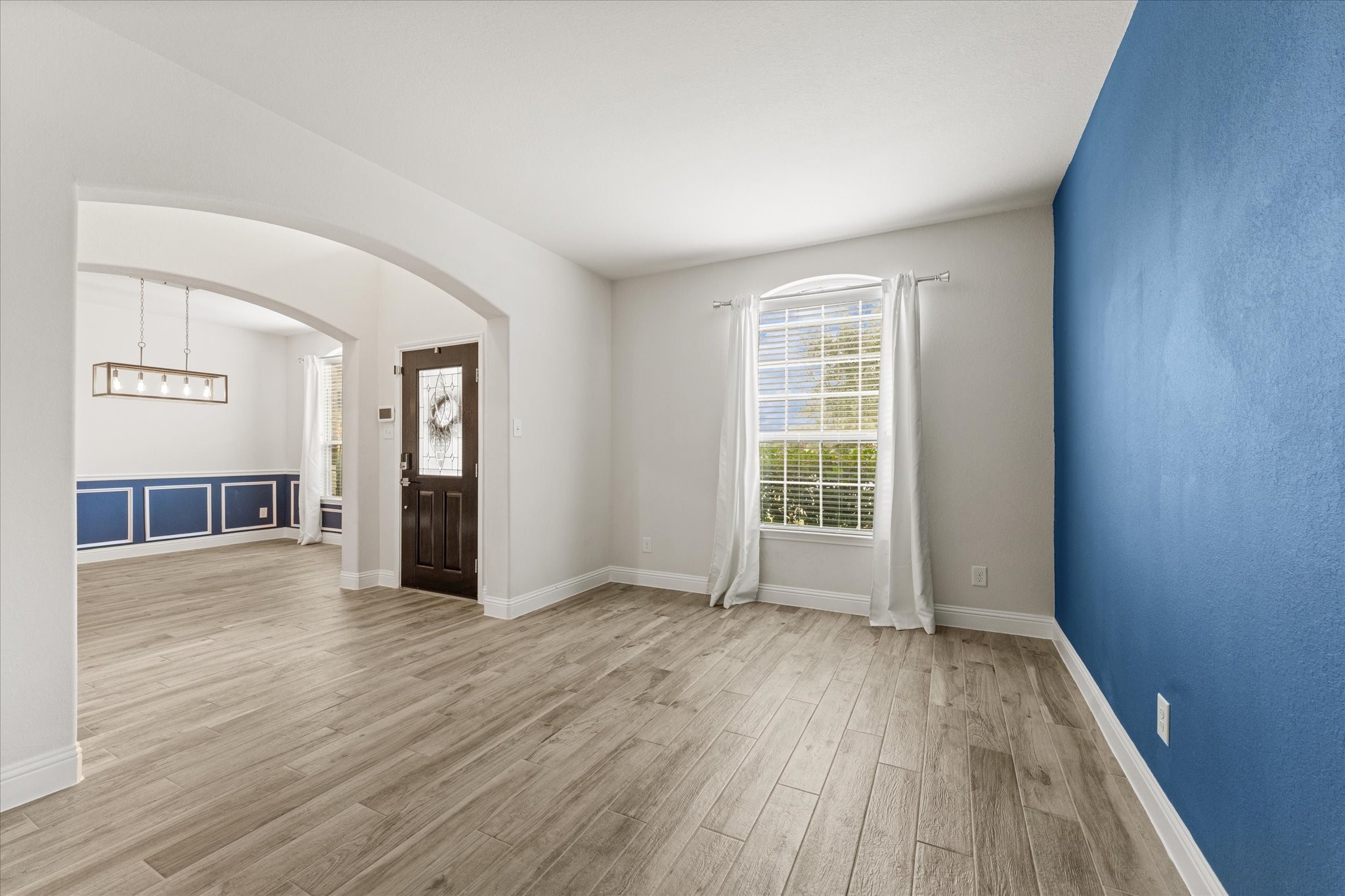 3402 Dryer Park Drive Spring, TX 77373 - Photo 7 of 40 Bright and inviting study with elegant flooring and a vibrant accent wall.
