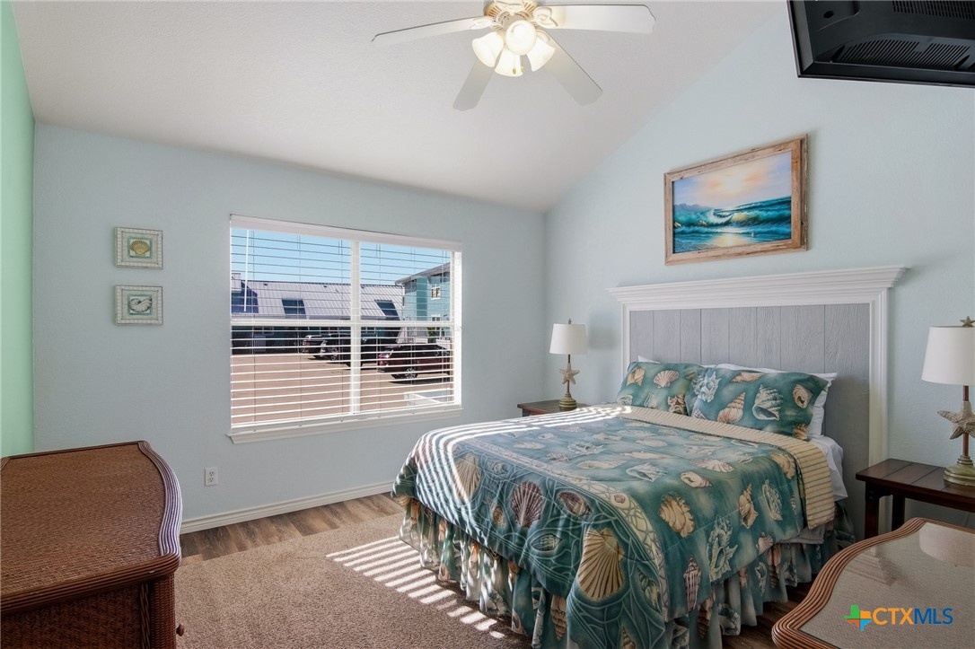 2292 North Fulton Beach Road, Unit 505 Rockport, TX 78382 - Photo 14 of 46 a bedroom with a bed a chair and a window