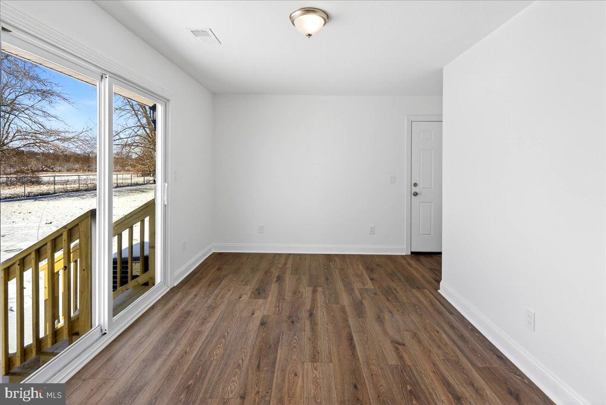 464 Sykesville Road Wrightstown, NJ 08562 - Photo 12 of 32 a view of an empty room with wooden floor and a window
