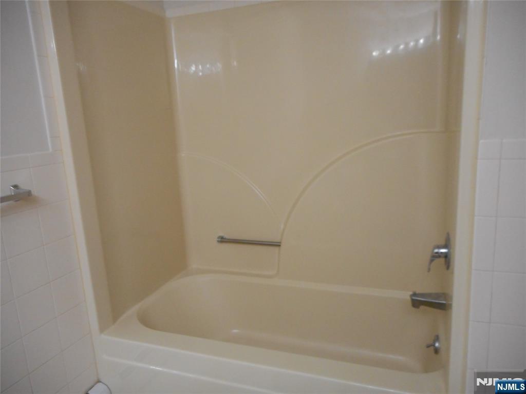 129 River Road, Unit 129 Clifton, NJ 07014 - Photo 16 of 21 a close view of a bathtub in bathroom