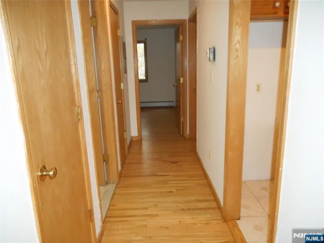 a view of a gallery with wooden floor