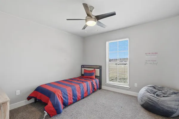 a bedroom with a bed and a television