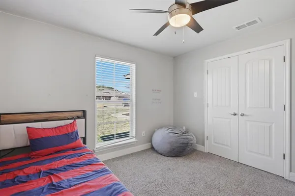 a bedroom with a large bed and a chandelier