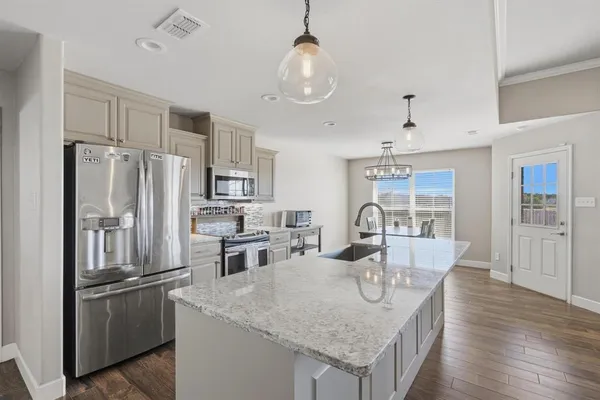 a kitchen that has a sink and a stove in it