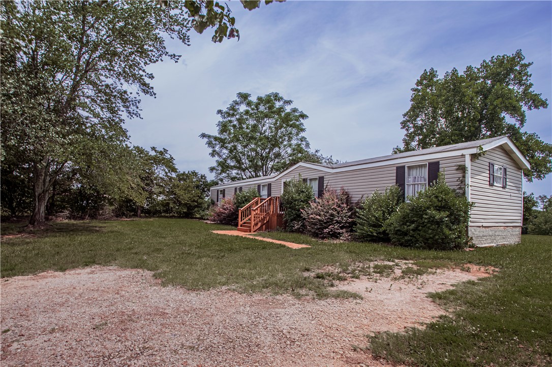 169 West Bagwell Road Liberty, SC 29657 - Photo 3 of 29 A well-maintained home awaits, surrounded by mature trees and verdant landscaping.