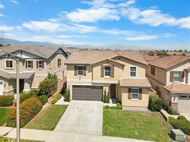 a front view of a residential houses with yard
