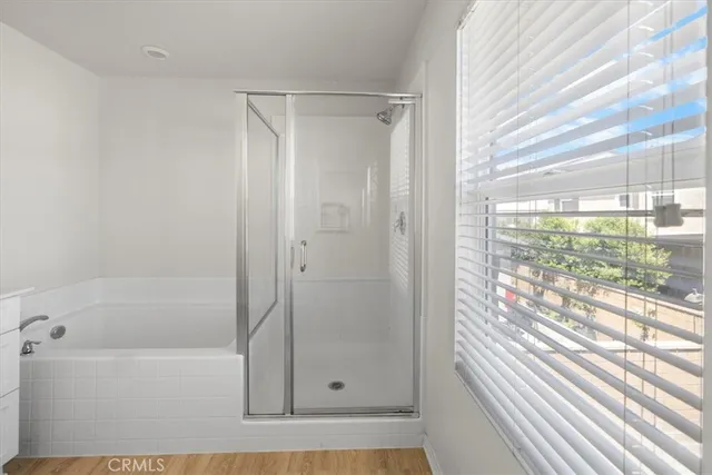 a bathroom with a granite countertop sink toilet a large mirror and shower