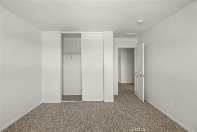 a view of a room with wooden floor and a window