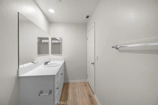 a bathroom with a granite countertop toilet and a shower