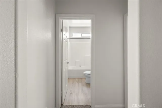 a bathroom with a granite countertop bathtub shower sink vanity and toilet