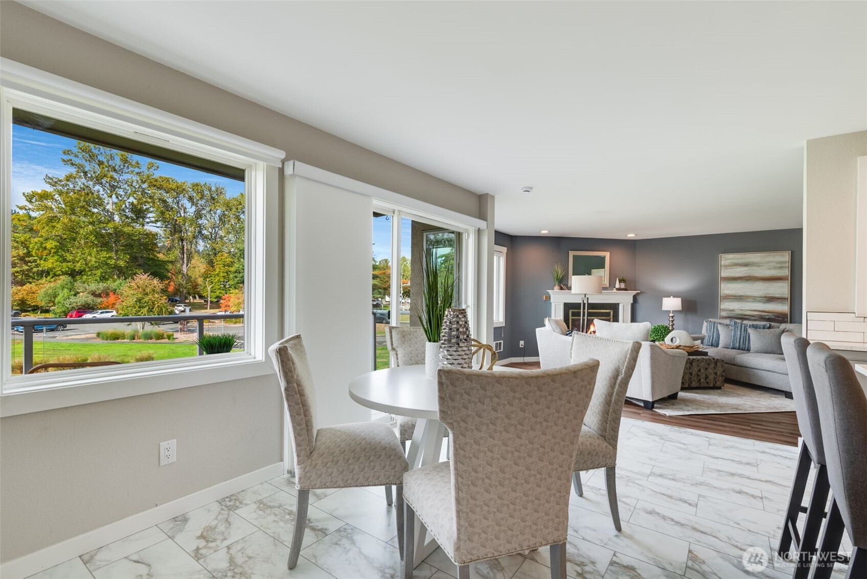 9715 Northeast Juanita Drive, Unit 206B Kirkland, WA 98034 - Photo 13 of 39 a view of a dining room with furniture window and wooden floor