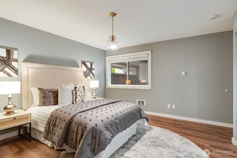 a bathroom with a double vanity sink and mirror with toilet