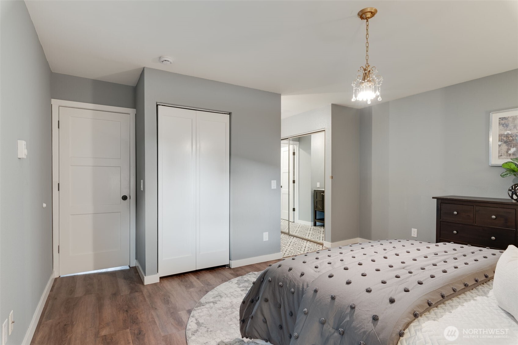 9715 Northeast Juanita Drive, Unit 206B Kirkland, WA 98034 - Photo 22 of 39 a bedroom with a bed and wooden floor