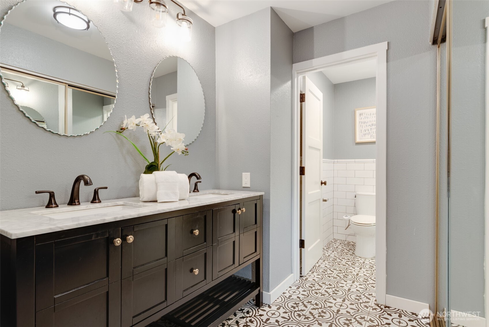 9715 Northeast Juanita Drive, Unit 206B Kirkland, WA 98034 - Photo 26 of 39 a bathroom with a double vanity sink and mirror with toilet