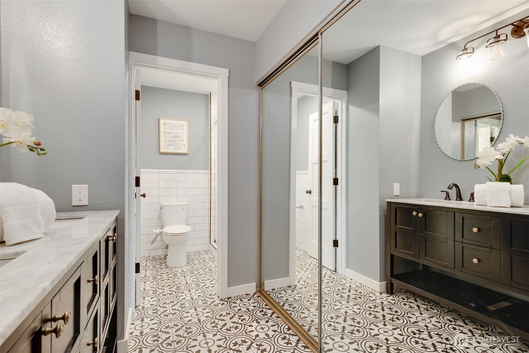 9715 Northeast Juanita Drive, Unit 206B Kirkland, WA 98034 - Photo 28 of 39 a bathroom with a sink a toilet and a mirror