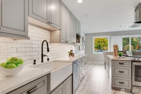 a kitchen with stainless steel appliances a refrigerator sink and cabinets
