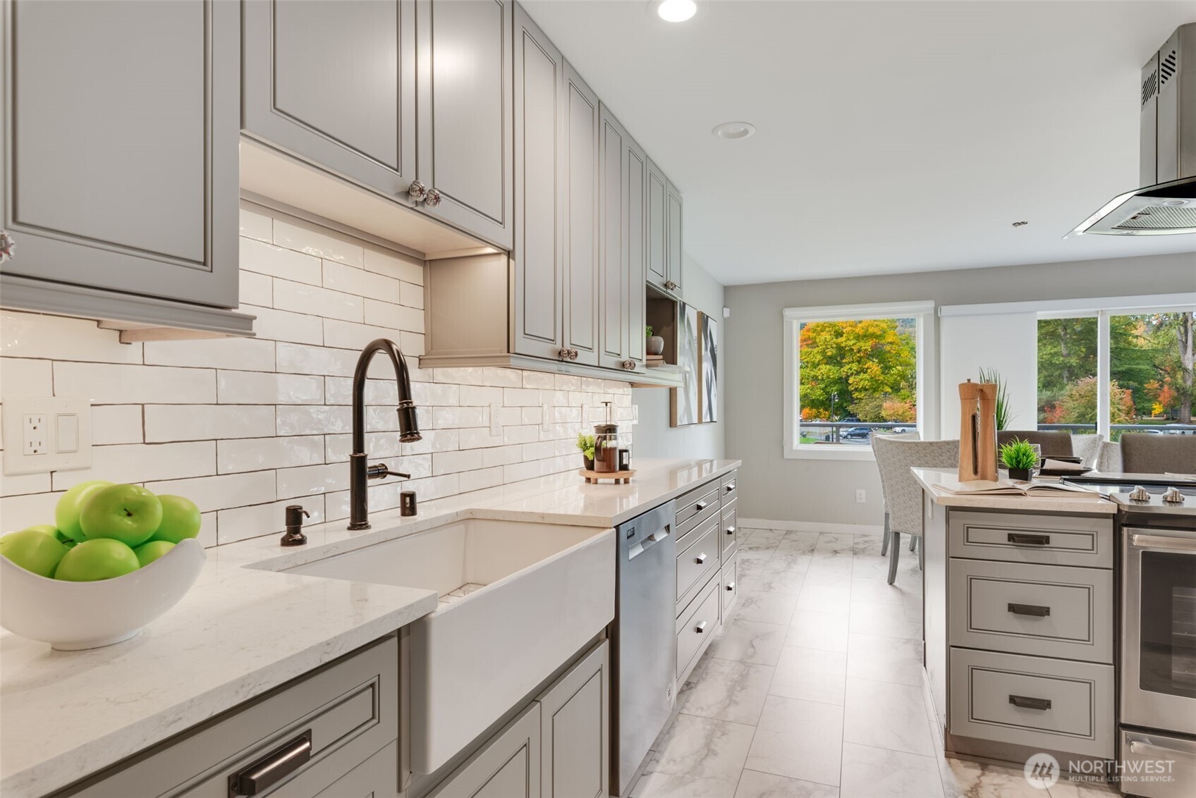 9715 Northeast Juanita Drive, Unit 206B Kirkland, WA 98034 - Photo 5 of 39 a kitchen with stainless steel appliances a sink a stove cabinets and a window