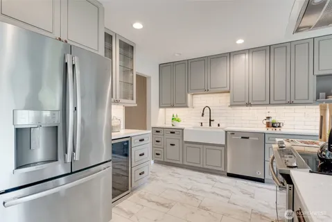 a kitchen with stainless steel appliances a sink stove and refrigerator