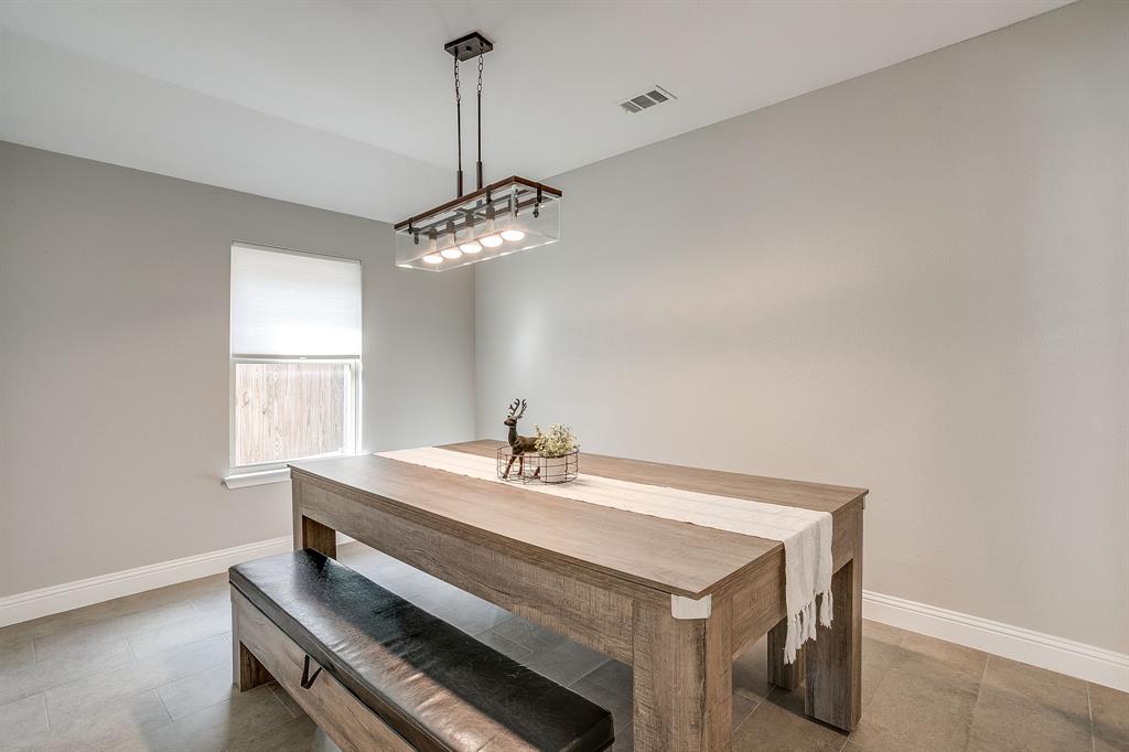 5617 Kilpatrick Avenue Fort Worth, TX 76107 - Photo 11 of 40 a dining room with a table and chairs