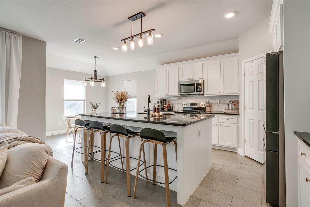 5617 Kilpatrick Avenue Fort Worth, TX 76107 - Photo 13 of 40 a kitchen with a sink stove and refrigerator