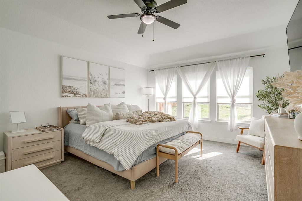 5617 Kilpatrick Avenue Fort Worth, TX 76107 - Photo 22 of 40 a bedroom with a bed and a large window