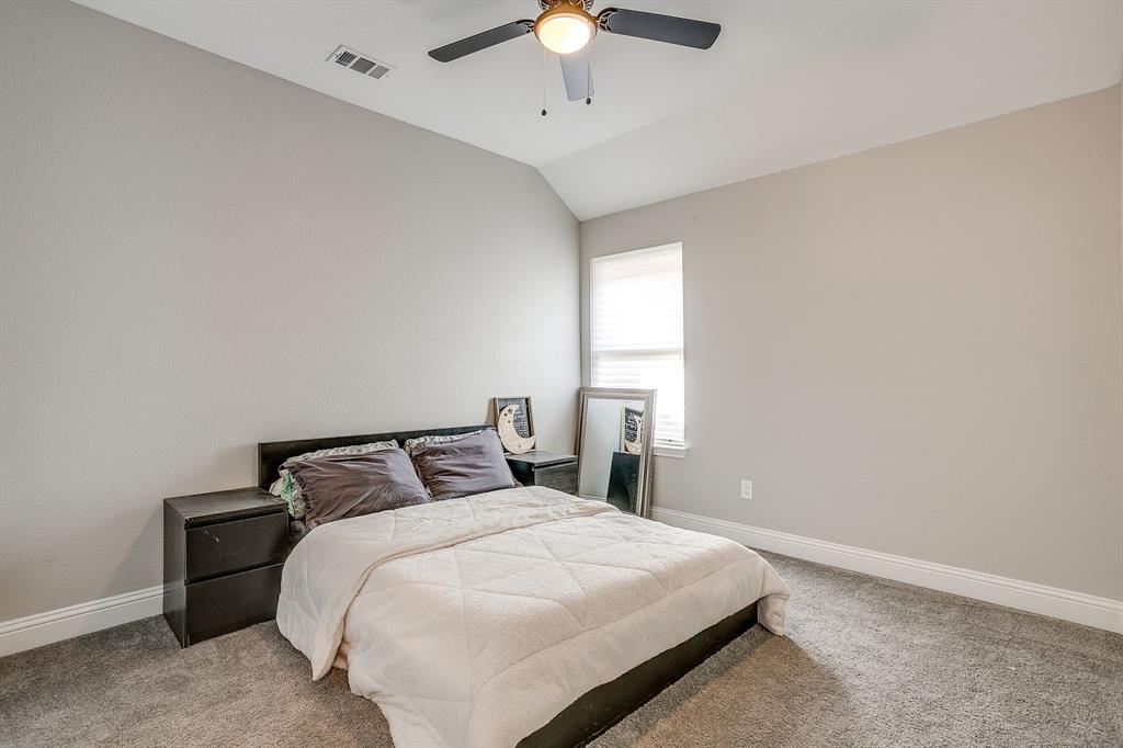 5617 Kilpatrick Avenue Fort Worth, TX 76107 - Photo 29 of 40 a bedroom with a bed and a chandelier