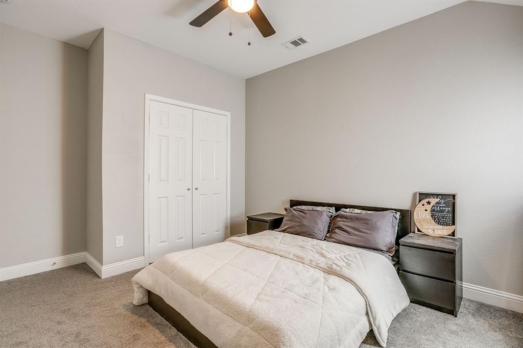 5617 Kilpatrick Avenue Fort Worth, TX 76107 - Photo 30 of 40 a bedroom with a bed and a ceiling fan